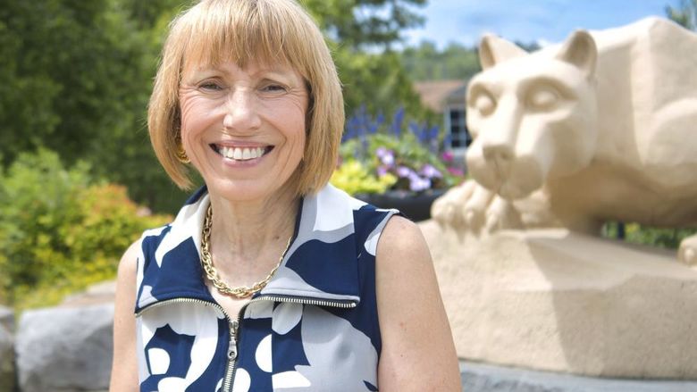 Dr. Darlne Dunay poses for a photo by the scranton campus' Nittany Lion Shrine
