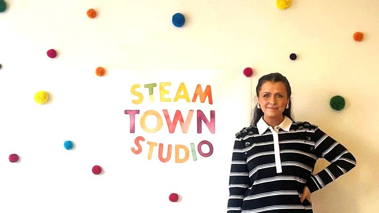 Emily Pinto stands in front of her Steam Town Studio business