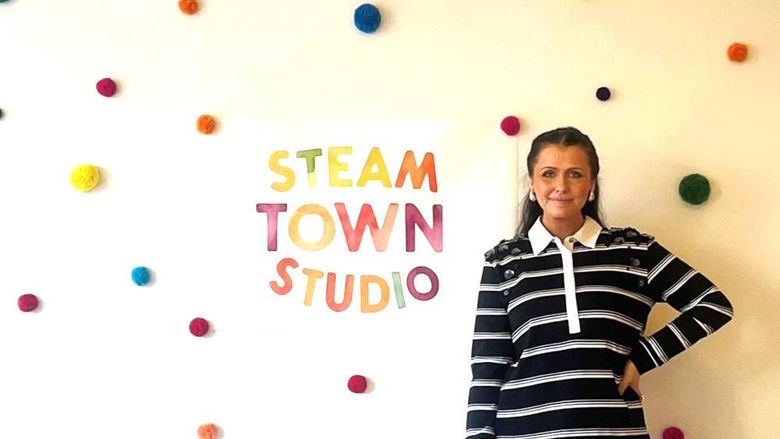 Emily Pinto stands in front of her Steam Town Studio business