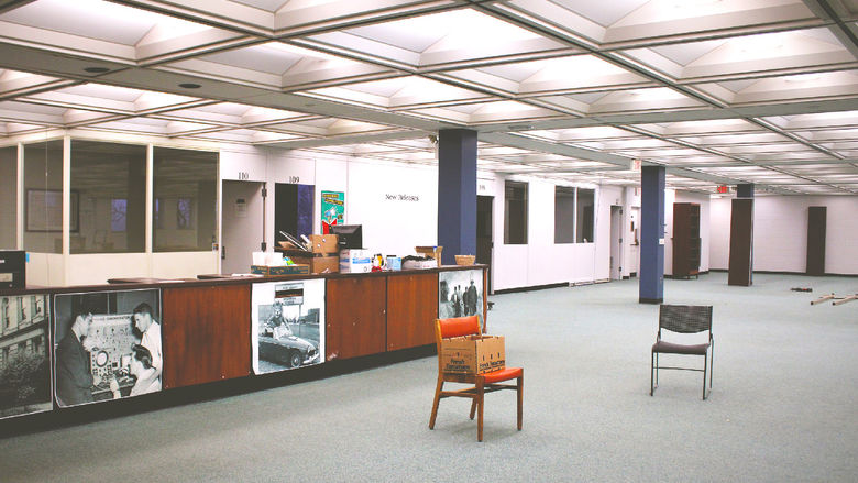 The main floor and circulation desk of the library now empty of all furniture and books