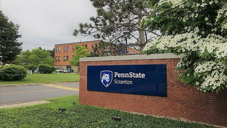 main entrance to Scranton campus with driveway and brick wall with Penn State Scranton sign on it