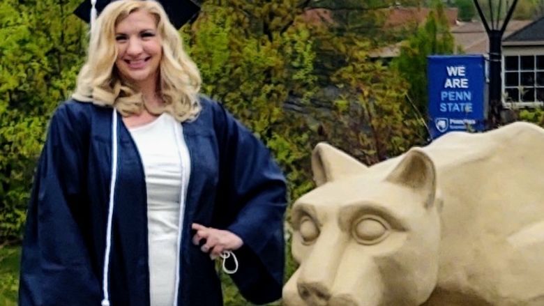 Erika Wheeler in cap and gown posing for photo at Scranton Lion Shrine