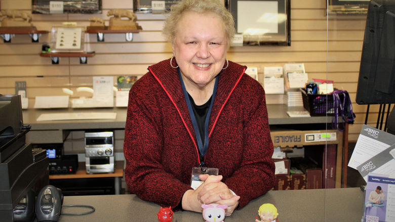 Evelyn Miller stands at the bookstore counter