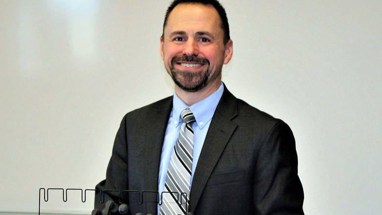 Frank Sorokach in front of whiteboard in classroom