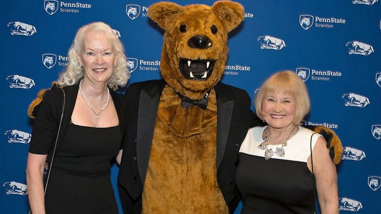 Former employees Margie and juliet pose with the Nittany Lion