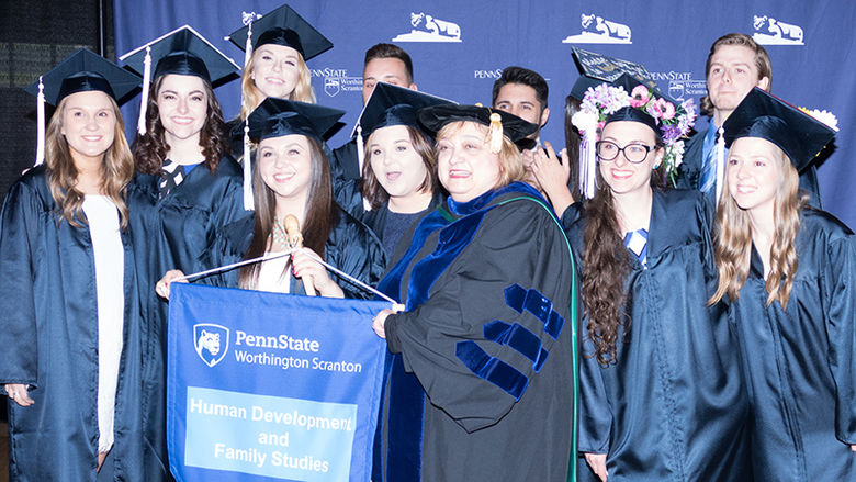 Group of graduates holding a Human Development & Family Studies  sign