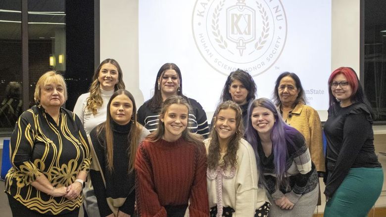 posed group of new student inductees standing with HDFS faculty