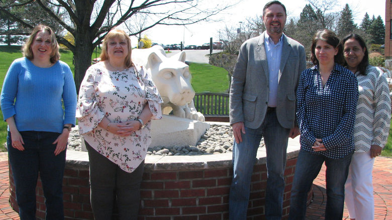 Photo of Human Development and Family Studies Faculty standing round the campus Nittany Lion, 2018.