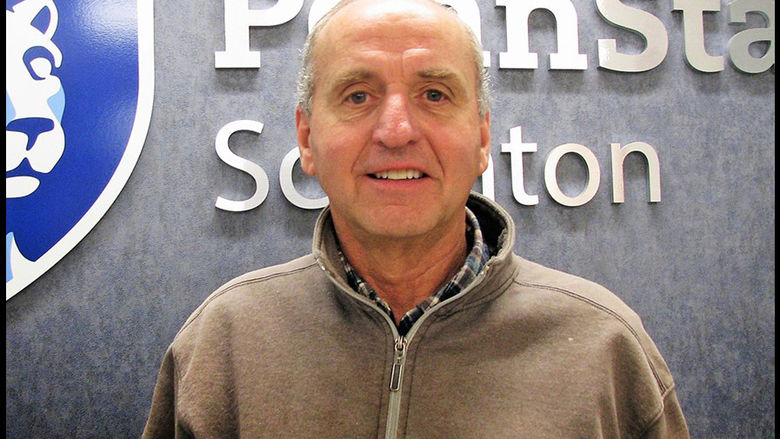 headshot of Jake Hinton standing in front of Penn State Scranton wall