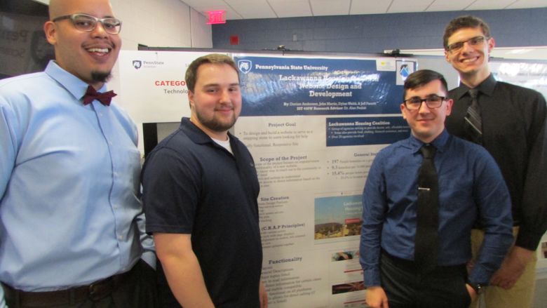 Students showing project at research fair