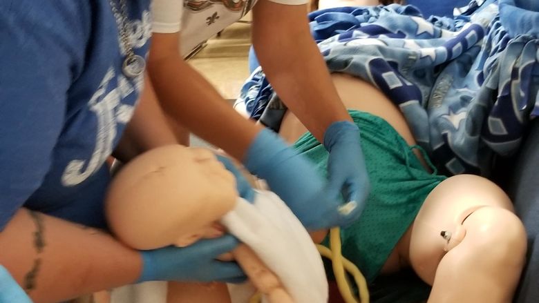 Sim mom delivers baby with lots of help