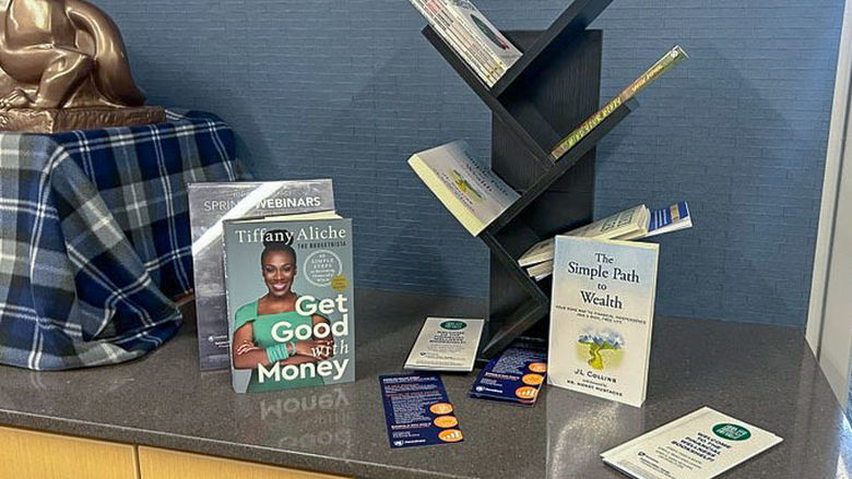 Books and brochures on financial wellness on a table in the admissions office