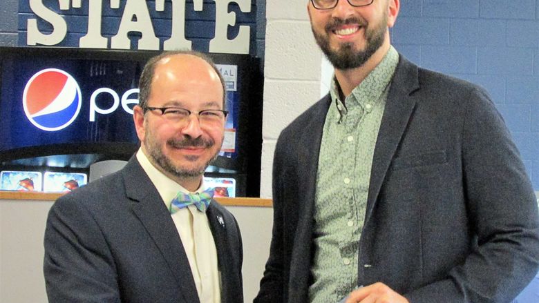 Brad Kovaleski receives his award from Dr. Marwan Wafa