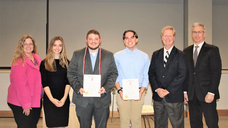 Lambda Pi Eta honor cord recipients pose with faculty members after cording ceremony