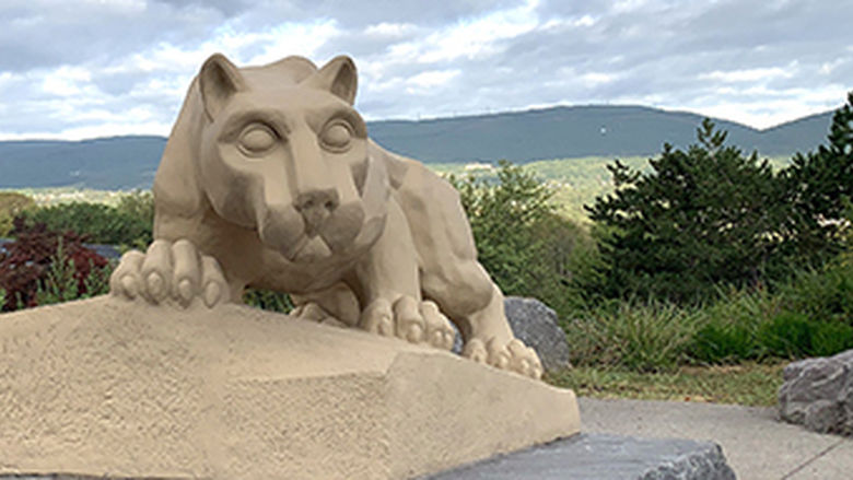 Nittany lion shrine with mountains and trees in background