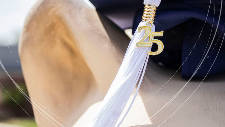 graduation cap positioned on top of nittany lion statue