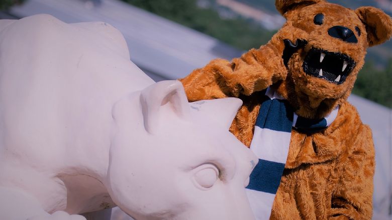 The Nittany Lion standing next to Nittany Lion Shrine