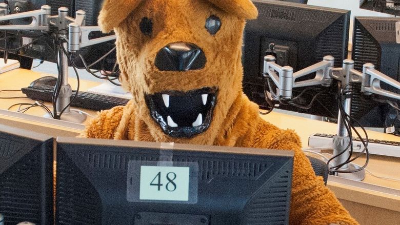 nittany lion mascot at a computer in a campus computer lab