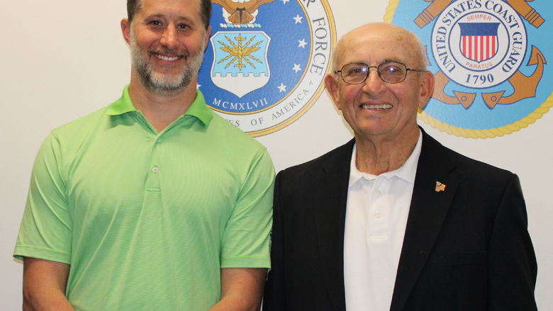 Campus alumnus EJ Long poses for a photo in the new Veterans Lounge at Penn State Scranton with retired dean of students Pat Rose