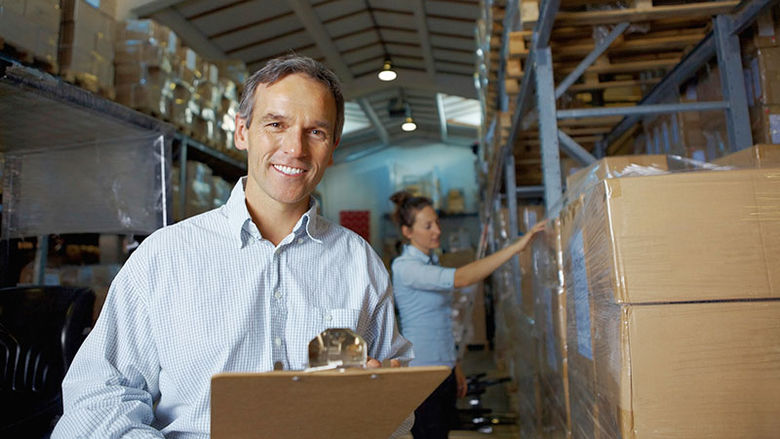 manager with clip board in a warehouse