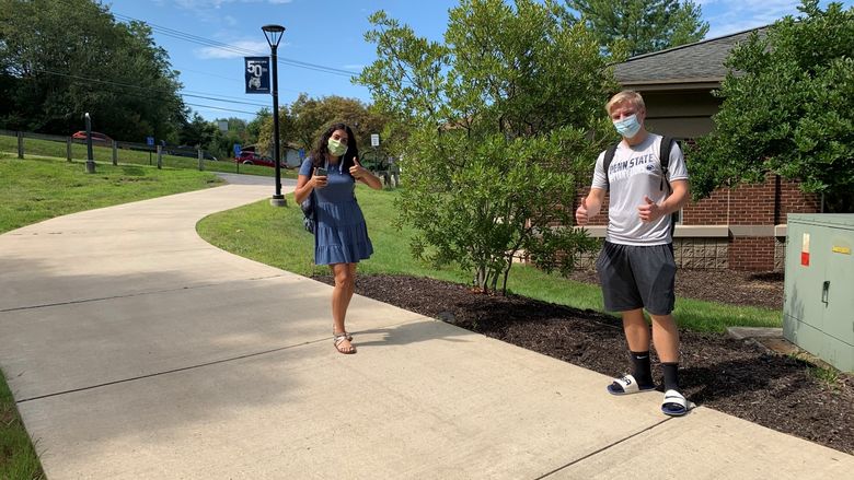 students on campus wearing face masks