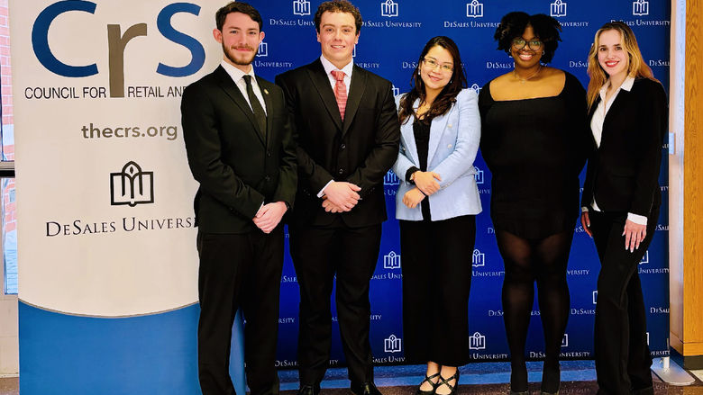 Professor Emily Pham poses for a photo with her four students who participated in a business competion at DeSales University