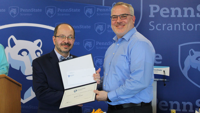 man receives certificate from another man