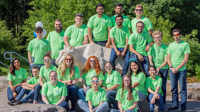 group of about twenty students outside near the Lion Shrine in matching orientation tees