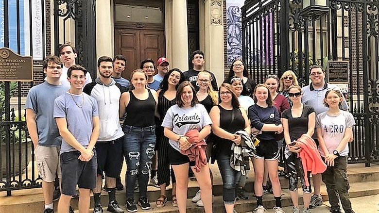 group of about twenty students outside ornate historical building in Philadelphia