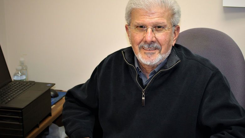 Paul Perrone seated in his office at his desk