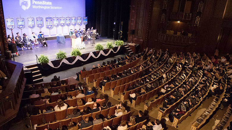 large group of people in theater for a graduation ceremony 