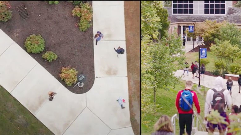 sply screen overhead of campus sidewalk from drone and students walking on campus sidewalk