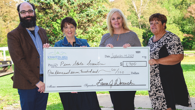 Scranton Foundation reps and Director of Development Chris Ostroski pose with grant check