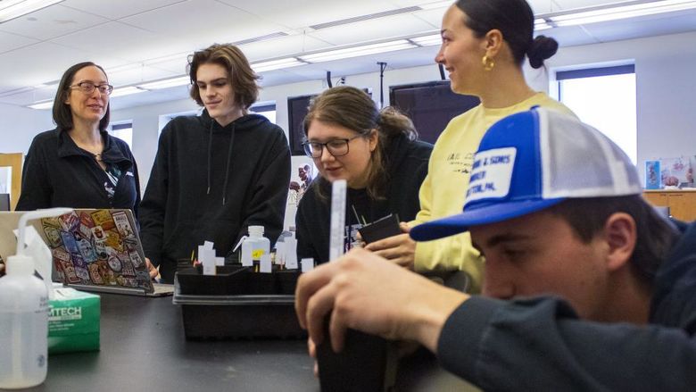 Professor Meg Van Etten and students work with plants in the campus' bio lab 