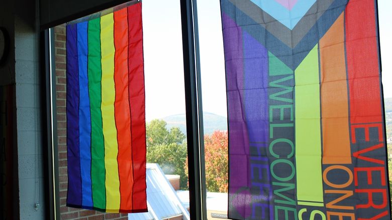 rainbow colored flags hand in the windows of The View Cafe on campus