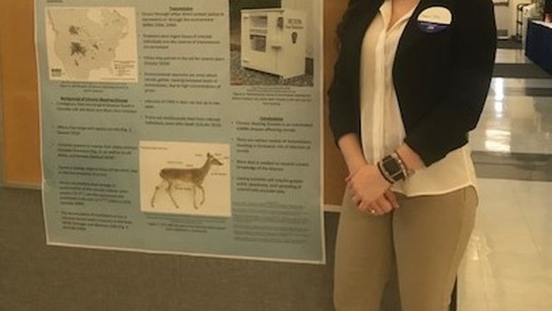 Student Cheyenne Tussel standing near her poster at the Penn State Eastern Regional Undergraduate Research Symposium at Penn State Hazleton, 2019