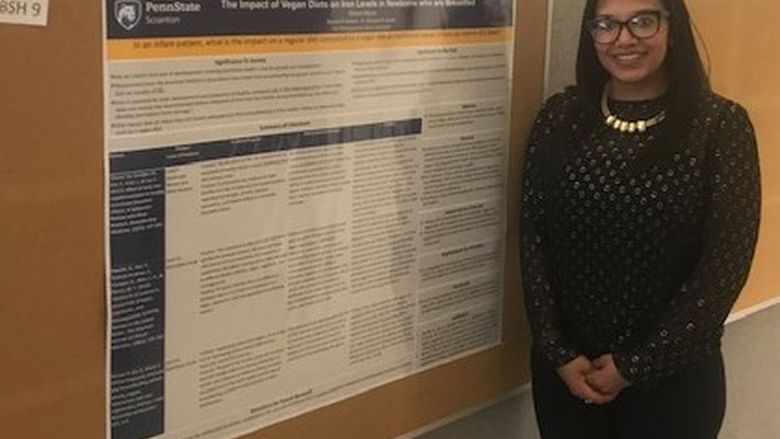 Student Brittany Hebron standing near her poster at the Penn State Eastern Regional Undergraduate Research Symposium at Penn State Hazleton, 2019