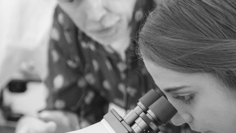 student looking on a microscope