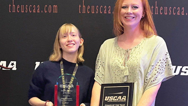 Megan Lucy and Sara Rinkunas holding their awards at USCAA awards ceremony