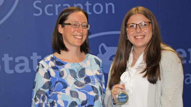 Fair coordinator Meg Van Etten presents Sarah Sherpinskas her first place award