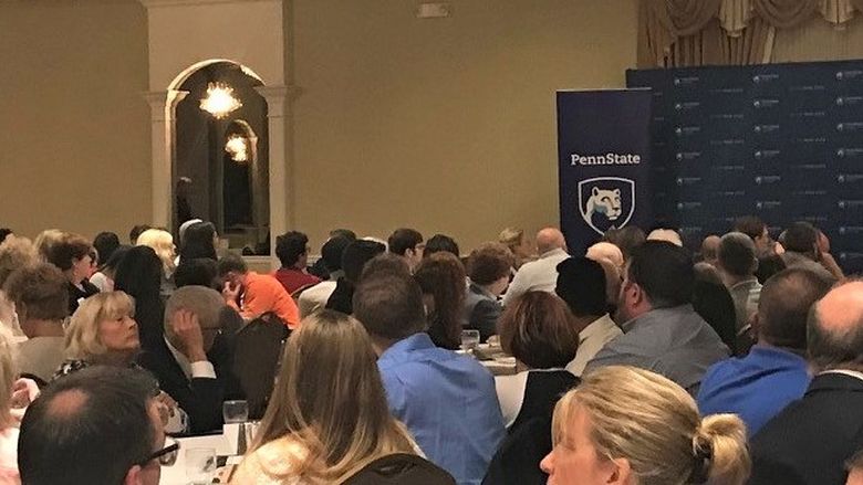 The scholarship reception attendees listening to Dr. Marwan Wafa's welcome