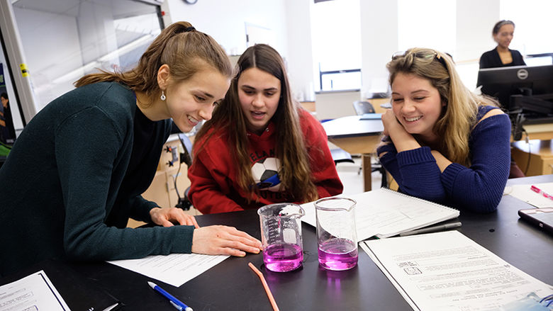 small group of students work on science experiment in class