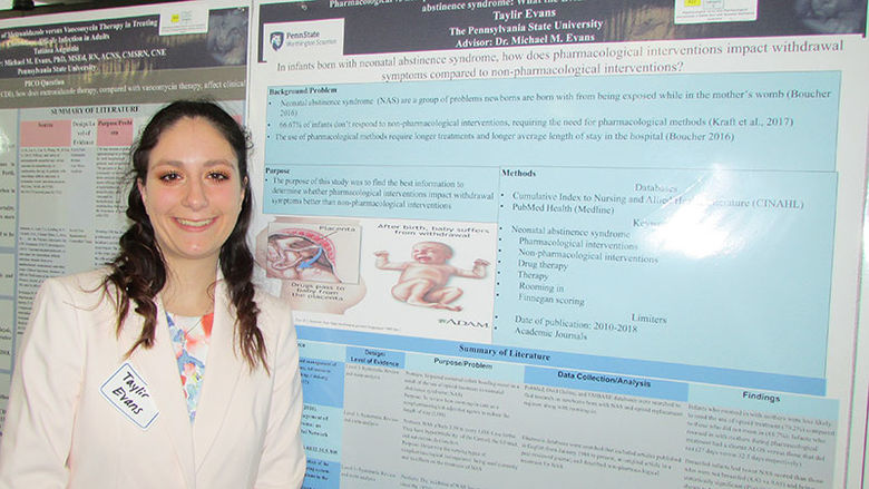 student with research poster