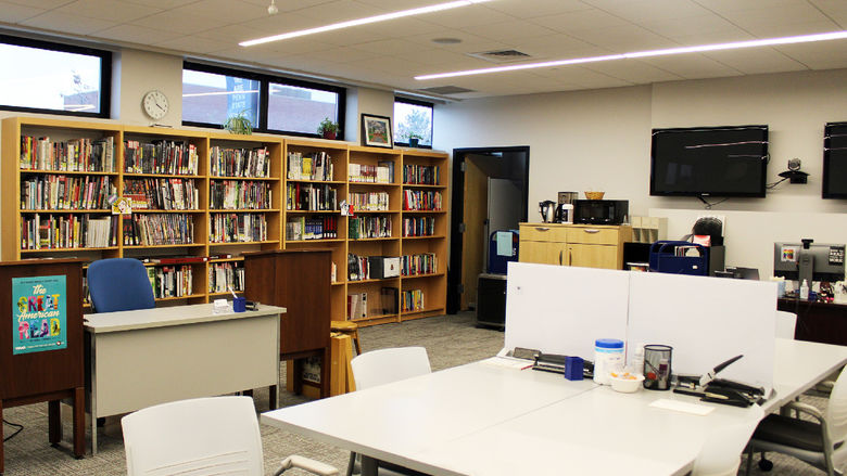 study tables and chairs, along with staff desks and bookshelves are set up in Dawson 10