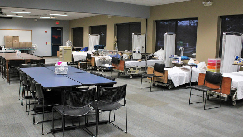hospital beds with patient simulators on them, and a conference table and chairs in GCC 112, the temporary home for nursing