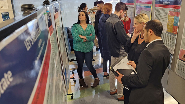 Attendees check out some of the poster displays at Scranton's research fair