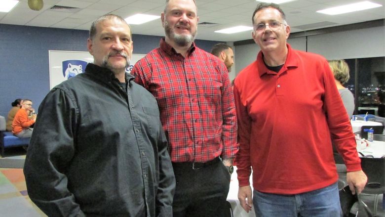 three veterans pose for a photo at the dinner