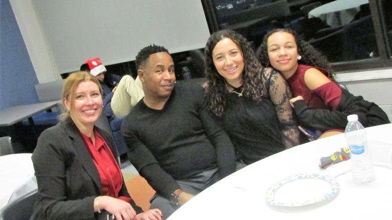 happy guests posing at table for group photo