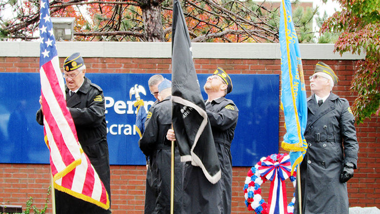 vets group raise flags during Veterans Day ceremony