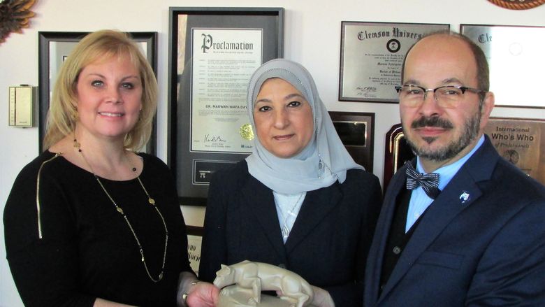 Dr. Wafa and wife receiving lion shrine statue